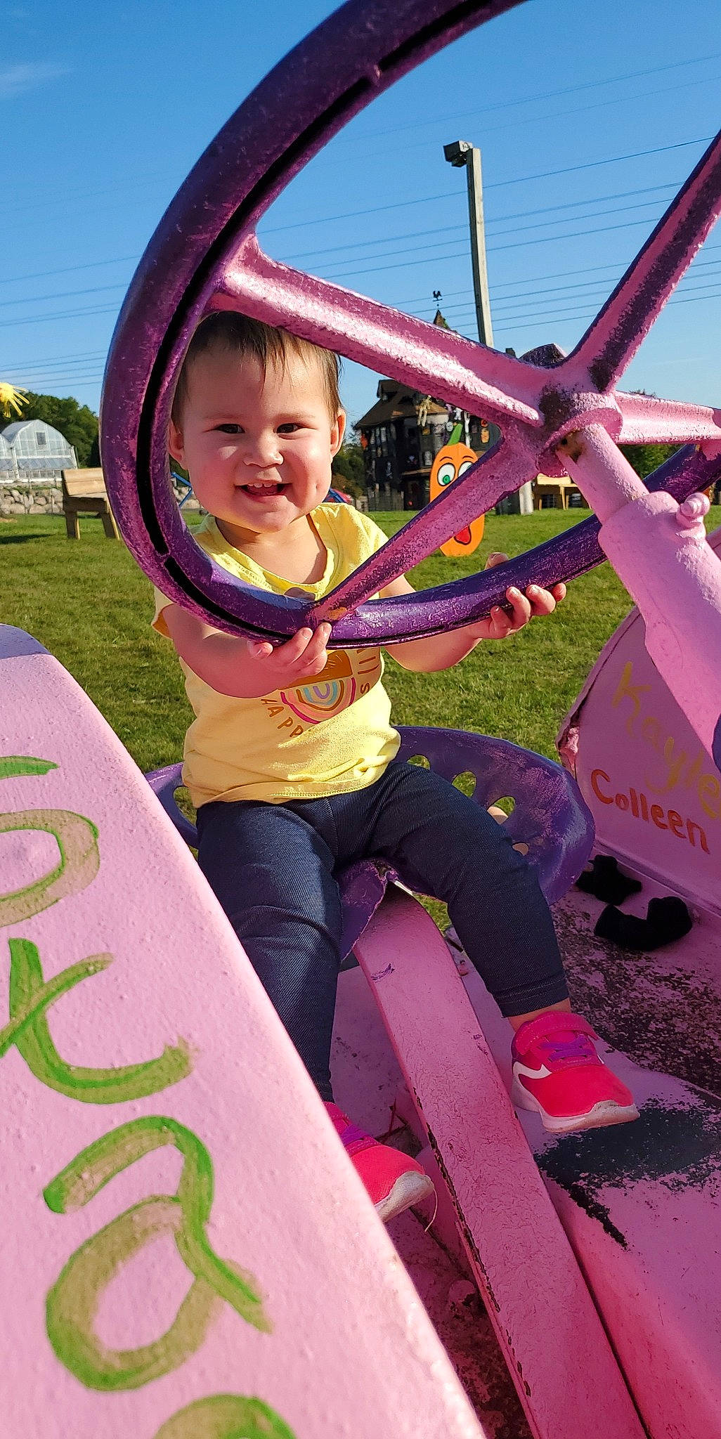 Raelynn is registered to the contest to win money with this photo: automotive_wheel_system, child, city, fun, grass, green, happy, joy, leisure, magenta, person, photograph, pink, public_space, purple, recreation, red, sky, smile, snapshot