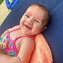 Amariah is registered to the contest to win money with this photo: baby, smiling, infant, swimsuit, towel, blue_surface, outdoor, happy, child, face, person, colorful, summer, relaxing, seat, green, striped, plush, skin, cute