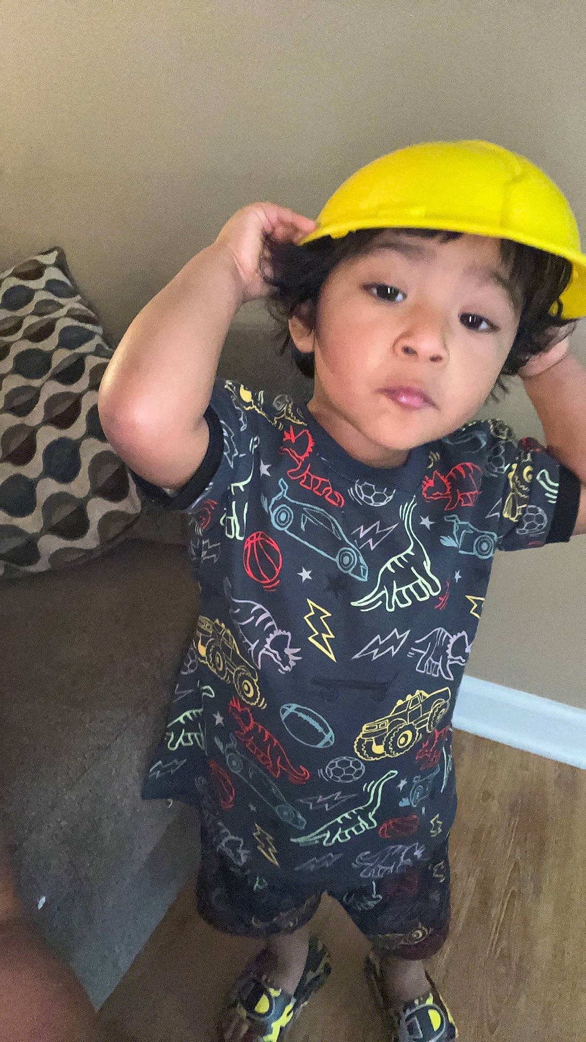Francisco is registered to the contest to win money with this photo: arm, baby_toddler_clothing, cap, child, elbow, fashion_accessory, finger, flooring, fun, happy, hard_hat, headwear, helmet, nose, pattern, person, personal_protective_equipment, sitting, skin, sleeve