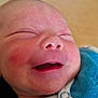 baby, baby_face, blue_clothing, child, closeup, cute, face, happy, indoors, infant, newborn, newborn_clothing, peaceful, person, portrait, rosy_cheeks, skin, sleepy, smiling, soft_light