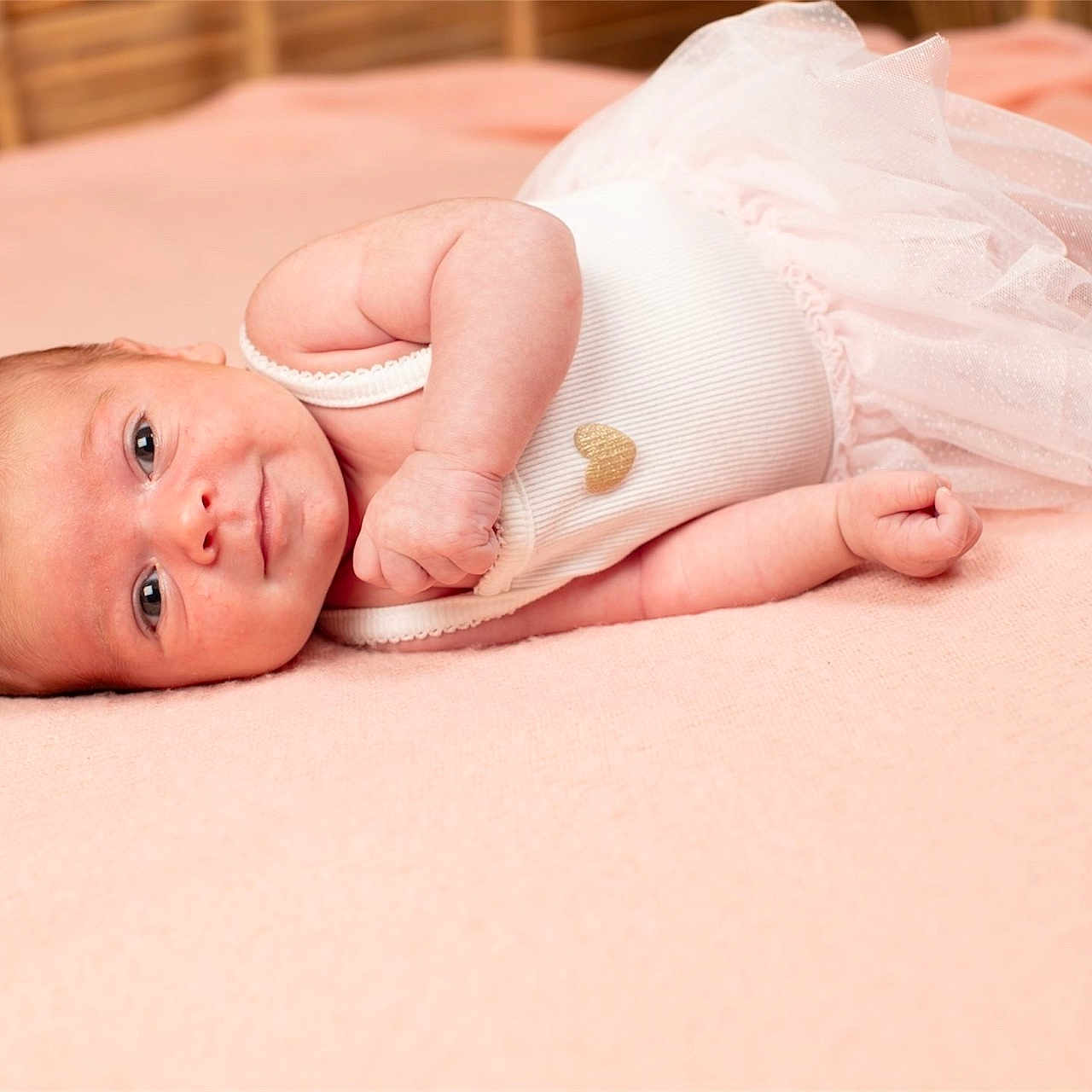 Ariana participe au concours pour gagner de l'argent avec cette photo : adorable, baby, blanket, clothing, cute, fabric, face, footwear, hand, heart, indoor, infant, lying_down, newborn, pink, portrait, skin, soft, sweet, tutu