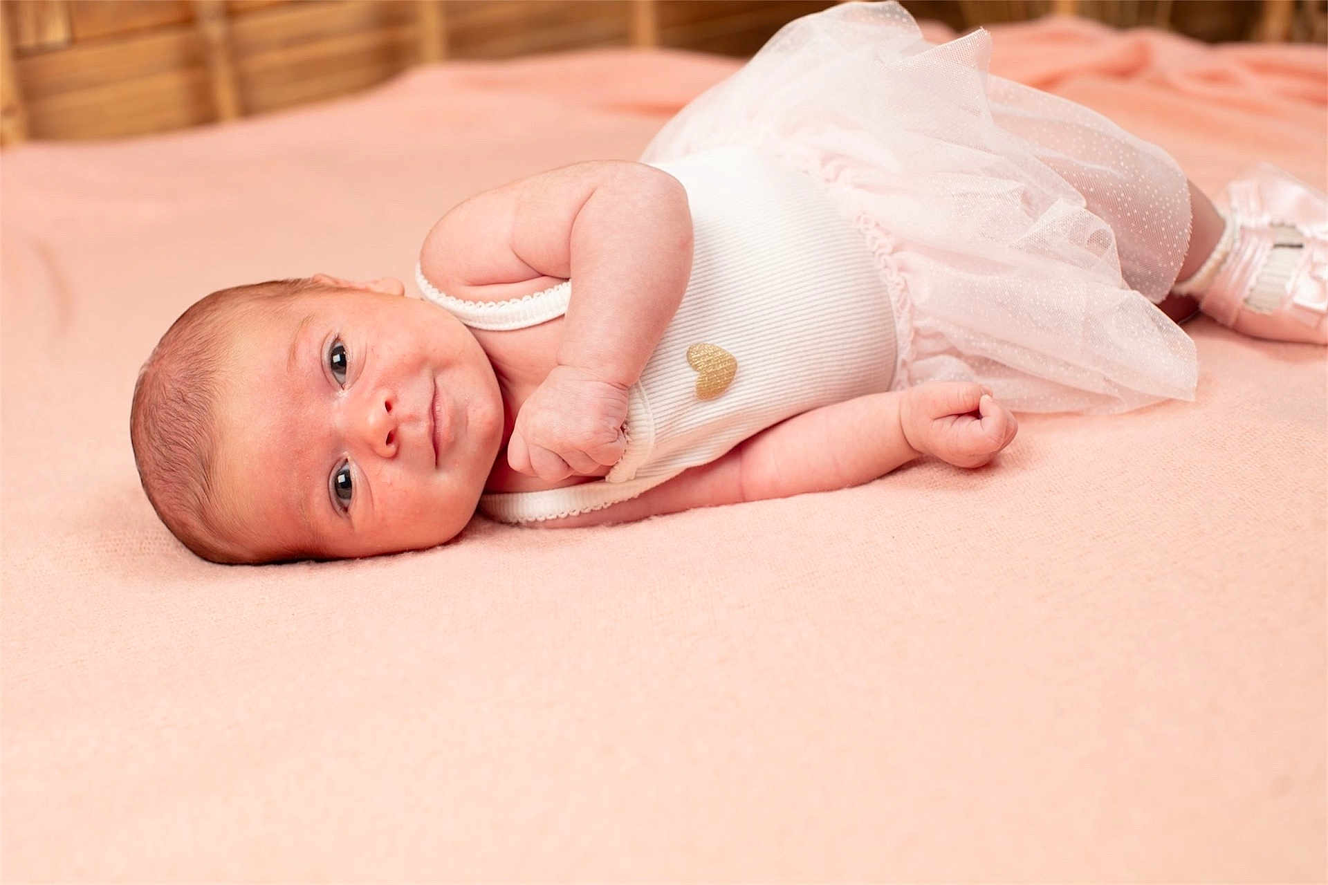 Ariana participe au concours pour gagner de l'argent avec cette photo : adorable, baby, blanket, clothing, cute, fabric, face, footwear, hand, heart, indoor, infant, lying_down, newborn, pink, portrait, skin, soft, sweet, tutu