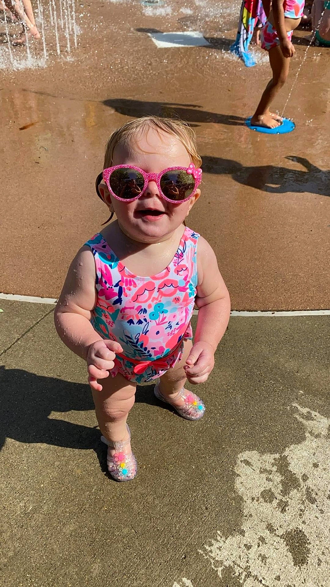 Renesmae is registered to the contest to win money with this photo: baby_toddler_clothing, child, eyewear, fun, goggles, hairstyle, happy, leisure, magenta, people, person, personal_protective_equipment, pink, public_space, recreation, smile, summer, sunglasses, toddler, vacation