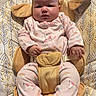 Raina joined the competition — help win amazing prizes! baby, infant, child, sitting, bouncer, baby_seat, pink_outfit, unicorn, socks, smiling_socks, face, portrait, indoors, cushion, blanket, patterned_fabric, harness, furniture, cozy, photograph