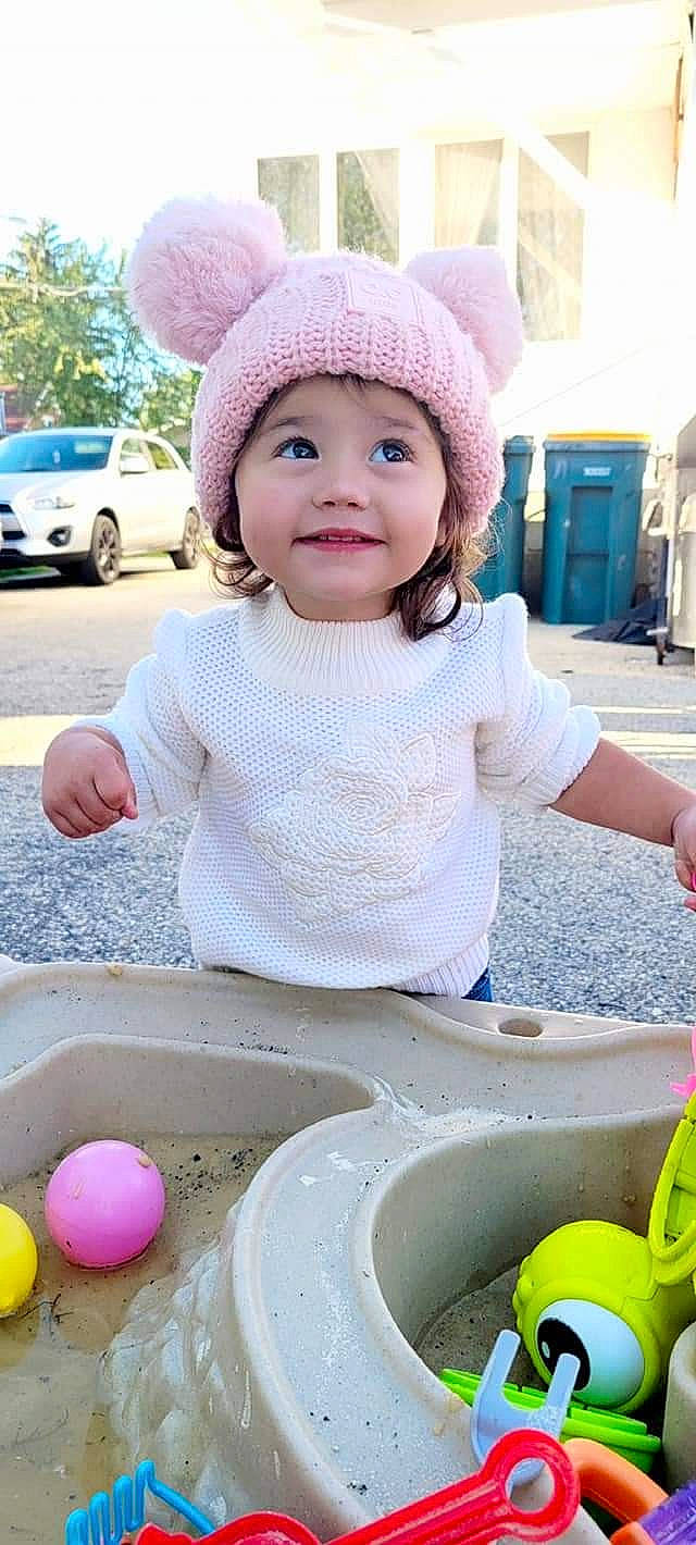 Renesmee is registered to the contest to win money with this photo: baby, baby_toddler_clothing, cap, car, child, face, fun, green, happy, hat, headwear, joy, people, person, photograph, pink, shorts, smile, snapshot, tire