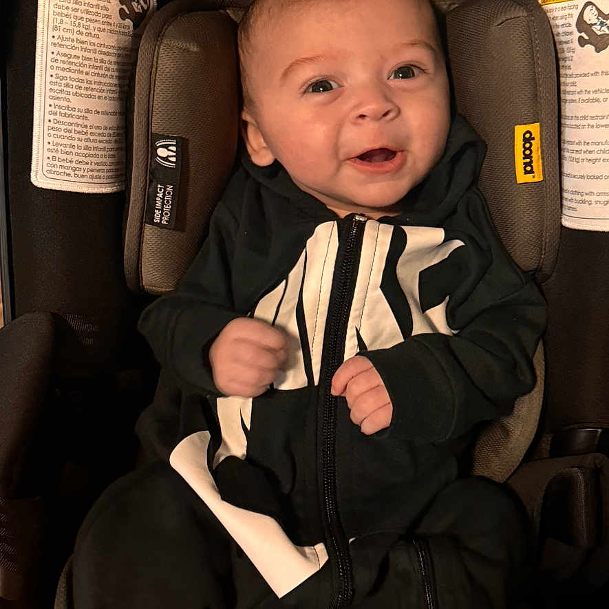 Aayan joined the competition — help win amazing prizes! baby, bodypart, car, car_interior, carseat, clothing, coat, cushion, face, finger, hand, head, homedecor, jacket, person, photography, portrait, sitting, transportation, vehicle