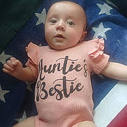 Charletta joined the competition — help win amazing prizes! baby, infant, onesie, pink_clothing, blanket, stars, face, child, lying_down, indoor, cute, expression, hand, soft_light, portrait, toddler, skin, person, apparel, young