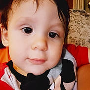 Kolton joined the competition — help win amazing prizes! child, toddler, face, smile, mickey_mouse, shirt, clothing, indoor, portrait, curly_hair, couch, pattern, wood, background, cute, young, person, happy, closeup, eyes
