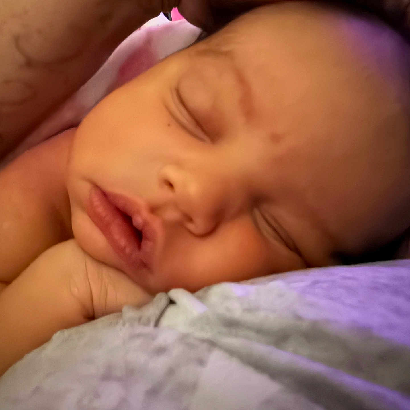 Serenity is registered to the contest to win money with this photo: baby, sleeping, infant, portrait, close_up, face, eyes_closed, peaceful, cozy, blanket, bed, bedding, indoors, warm_lighting, resting, lying_down, relaxed, child, soft_texture, nap