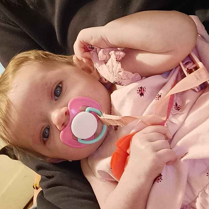 Vivviaan is registered to the contest to win money with this photo: baby, bodypart, bonnet, clothing, couch, cream, cutlery, dessert, eating, face, finger, food, furniture, hand, hat, head, newborn, person, spoon, sweets