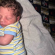 Omar joined the competition — help win amazing prizes! newborn, baby, sleeping, infant, child, face, curly_hair, striped_onesie, clothing, blanket, white_blanket, bed, bedding, cozy, indoors, portrait, peaceful, resting, closeup, photography