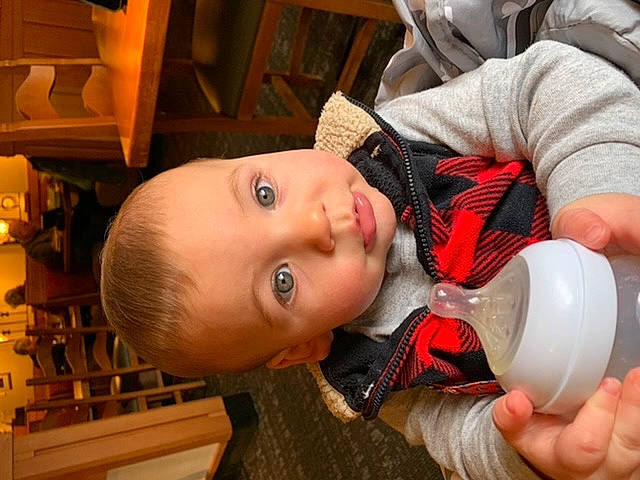 Landen joined the competition — help win amazing prizes! baby, baby_products, baby_toddler_clothing, bottle, cheek, child, drink, drinking, drinkware, fun, mouth, nail, nose, person, plastic_bottle, room, skin, smile, toddler, water
