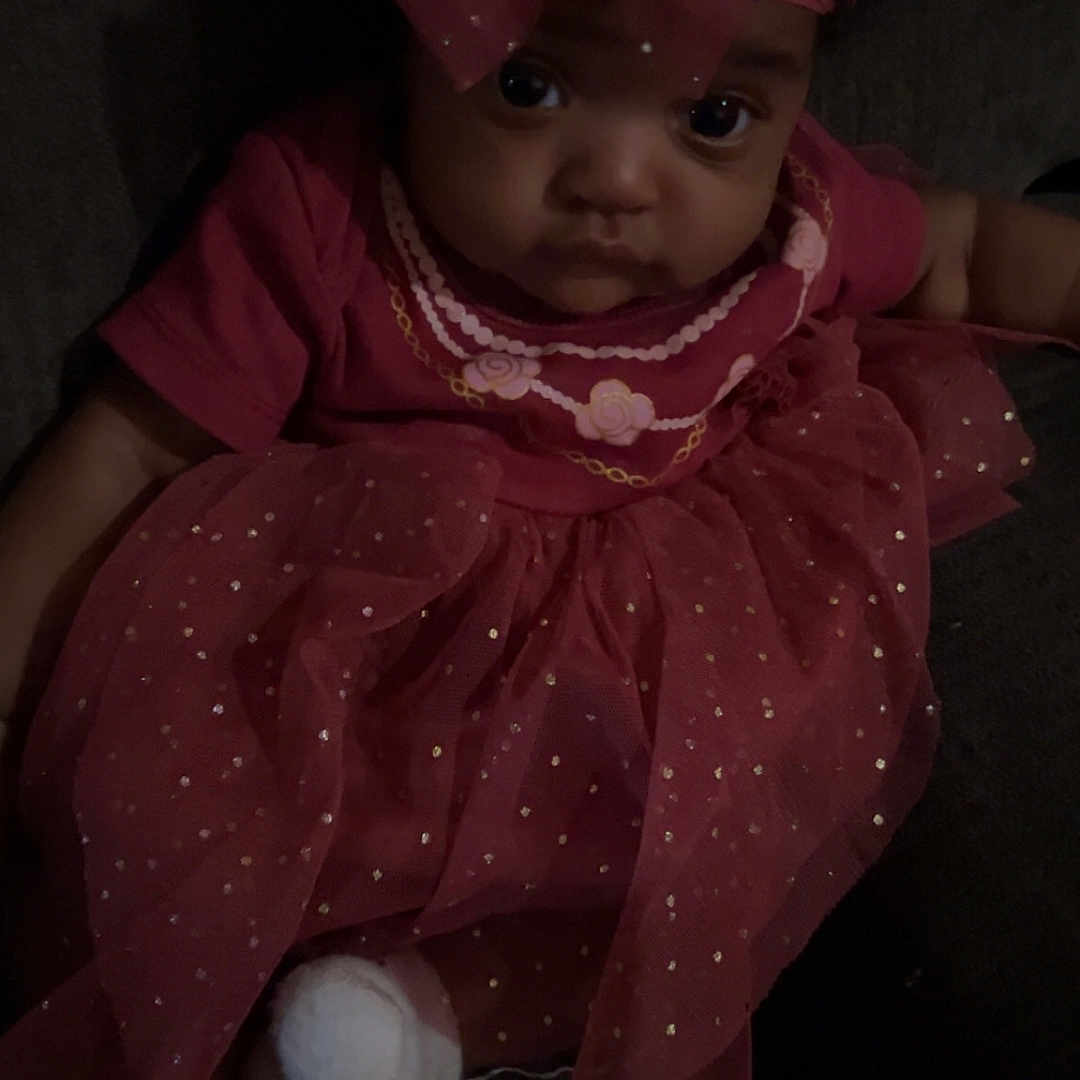 Naraiyah joined the competition — help win amazing prizes! baby, bodypart, bonnet, clothing, couch, dress, face, finger, formalwear, furniture, hand, happy, hat, head, person, photography, portrait, sitting, smile, toy