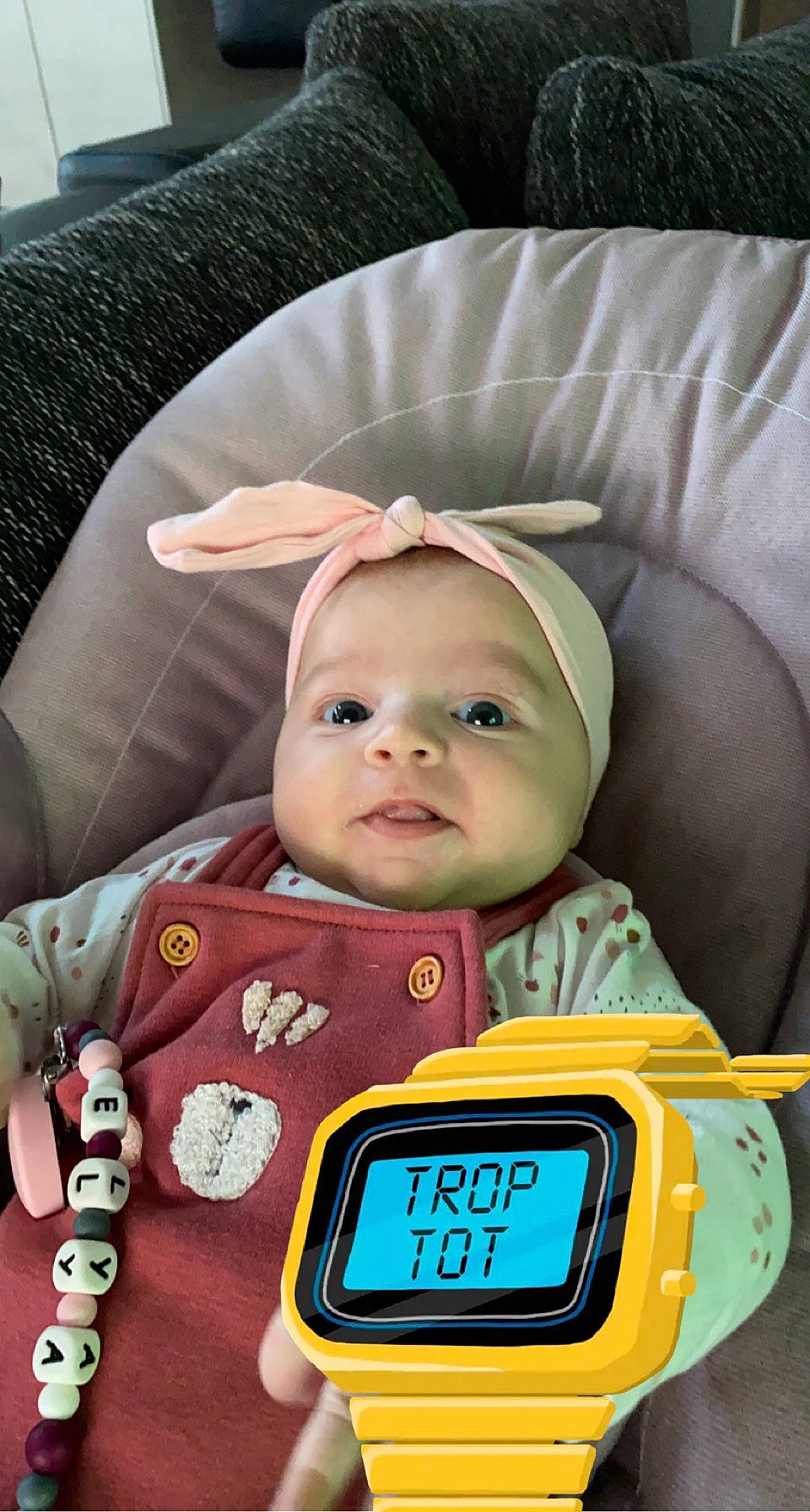 Elya a rejoint le concours — aidez-le/la à gagner de superbes lots ! alarm_clock, baby, baby_products, baby_safety, baby_toddler_clothing, cheek, child, clock, comfort, display_device, fun, gadget, green, happy, headwear, measuring_instrument, nose, person, product, service