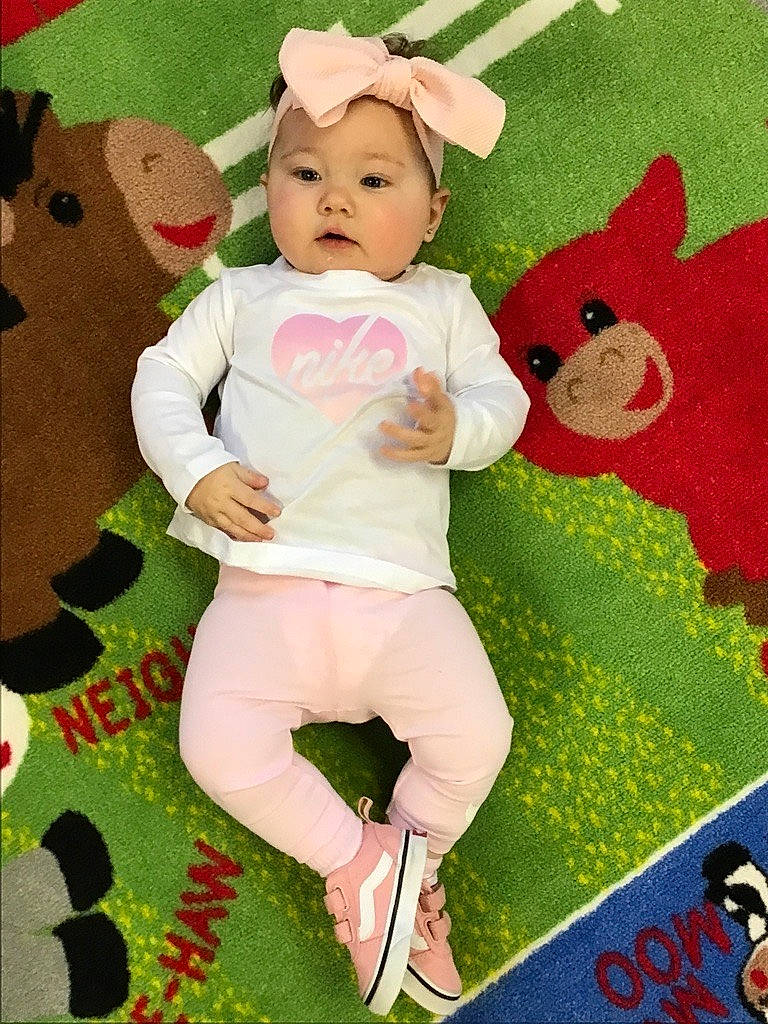 Kinsley is registered to the contest to win money with this photo: baby, baby_products, baby_toddler_clothing, carmine, child, fictional_character, flooring, grass, green, happy, headwear, pattern, peach, person, pink, plush, sleeve, stuffed_toy, textile, toddler