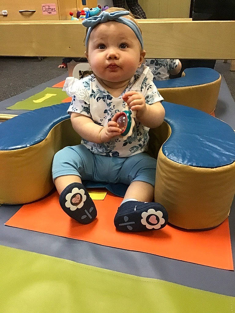 Kinsley is registered to the contest to win money with this photo: baby, baby_playing_with_toys, baby_toddler_clothing, child, flooring, fun, happy, human_leg, knee, leisure, person, play, recreation, room, sitting, smile, toddler, vacation