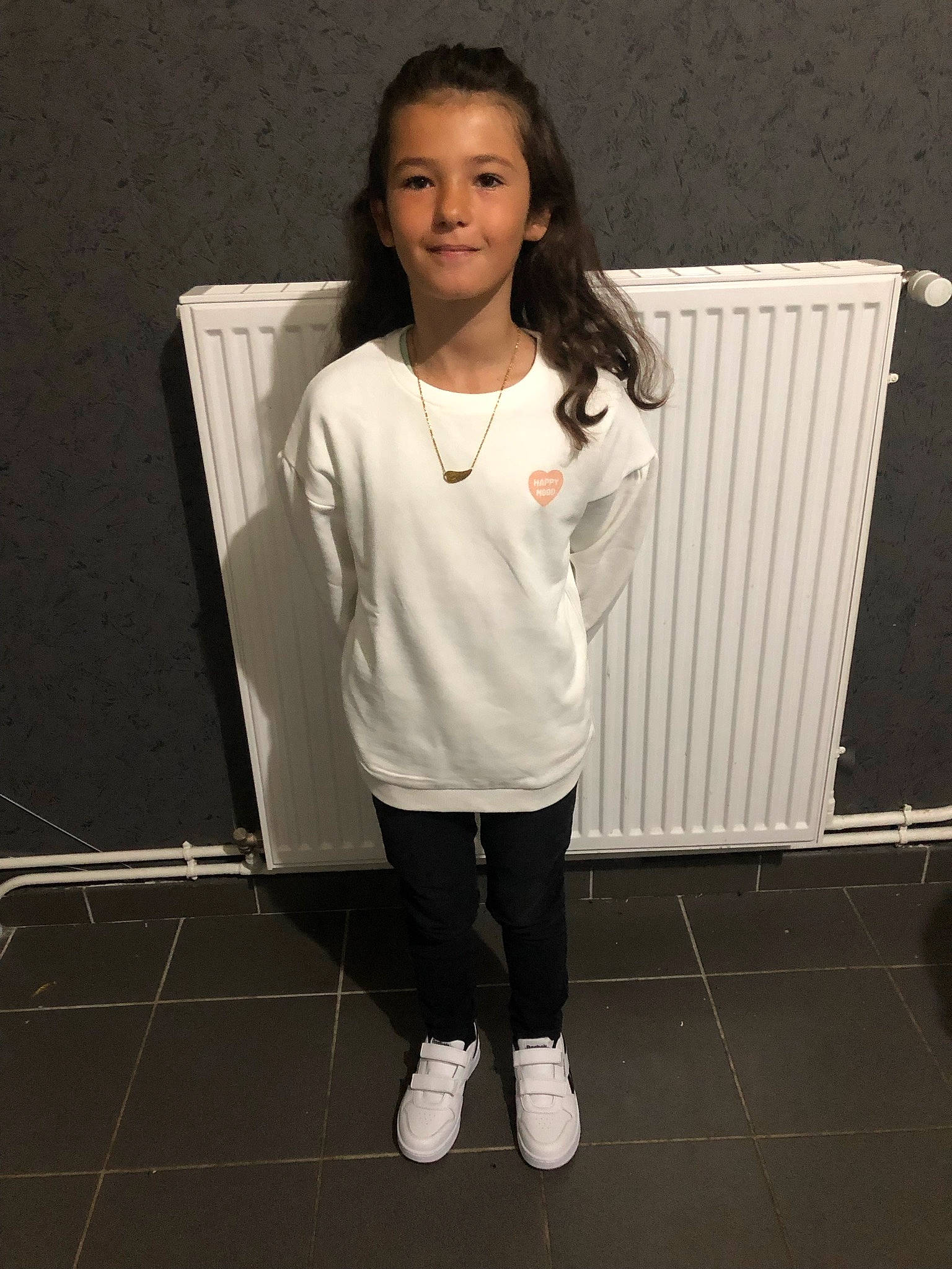 Maeva participe au concours pour gagner de l'argent avec cette photo : baby_toddler_clothing, beauty, elbow, event, fashion_design, flooring, hairstyle, happy, human_leg, joy, knee, neck, person, room, sleeve, smile, standing, street_fashion, t_shirt, thigh