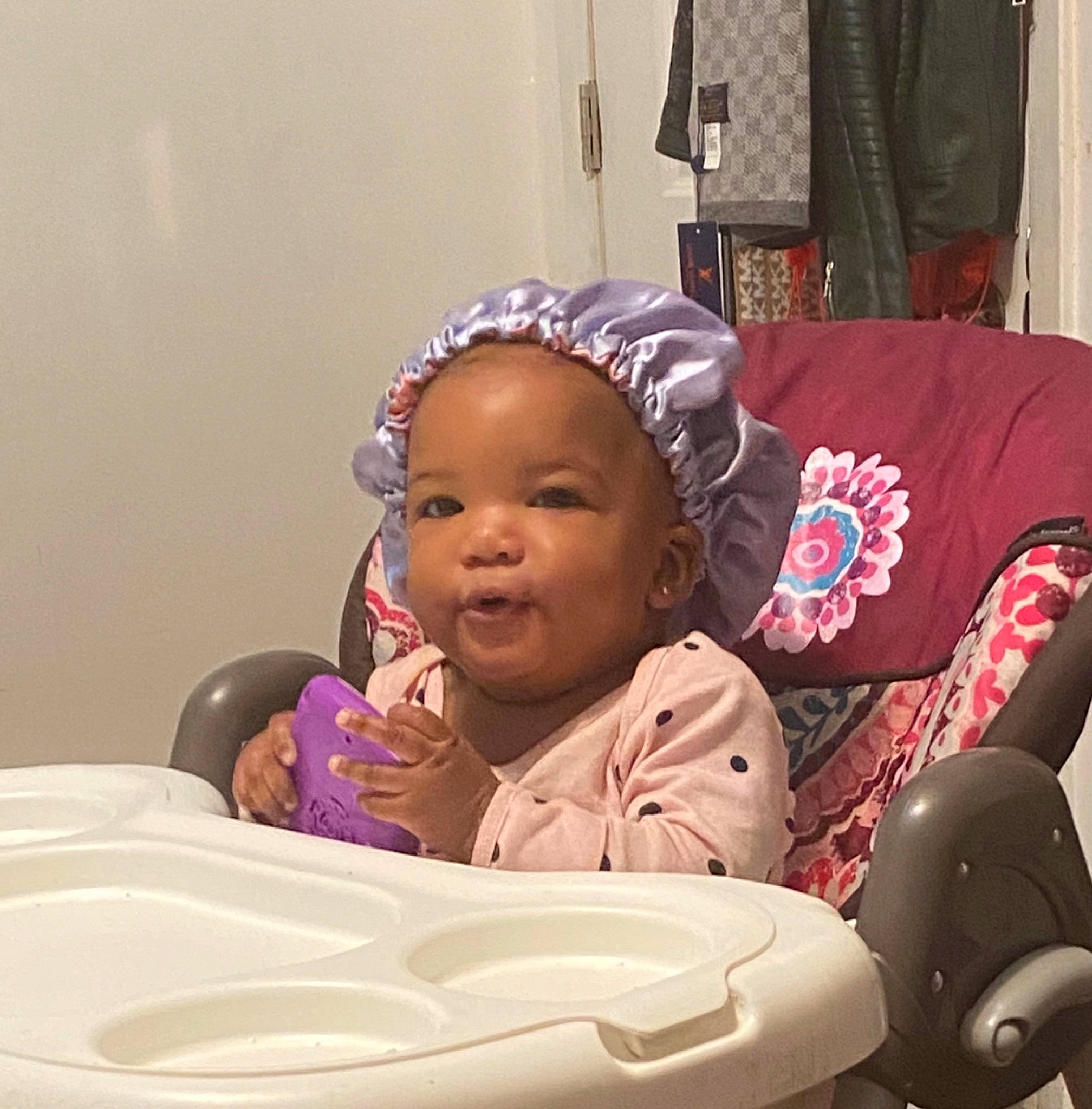 Janiyah is registered to the contest to win money with this photo: baby, baby_laughing, baby_products, baby_toddler_clothing, cheek, child, comfort, curtain, fun, happy, hat, laugh, magenta, mouth, person, pink, purple, room, sitting, smile
