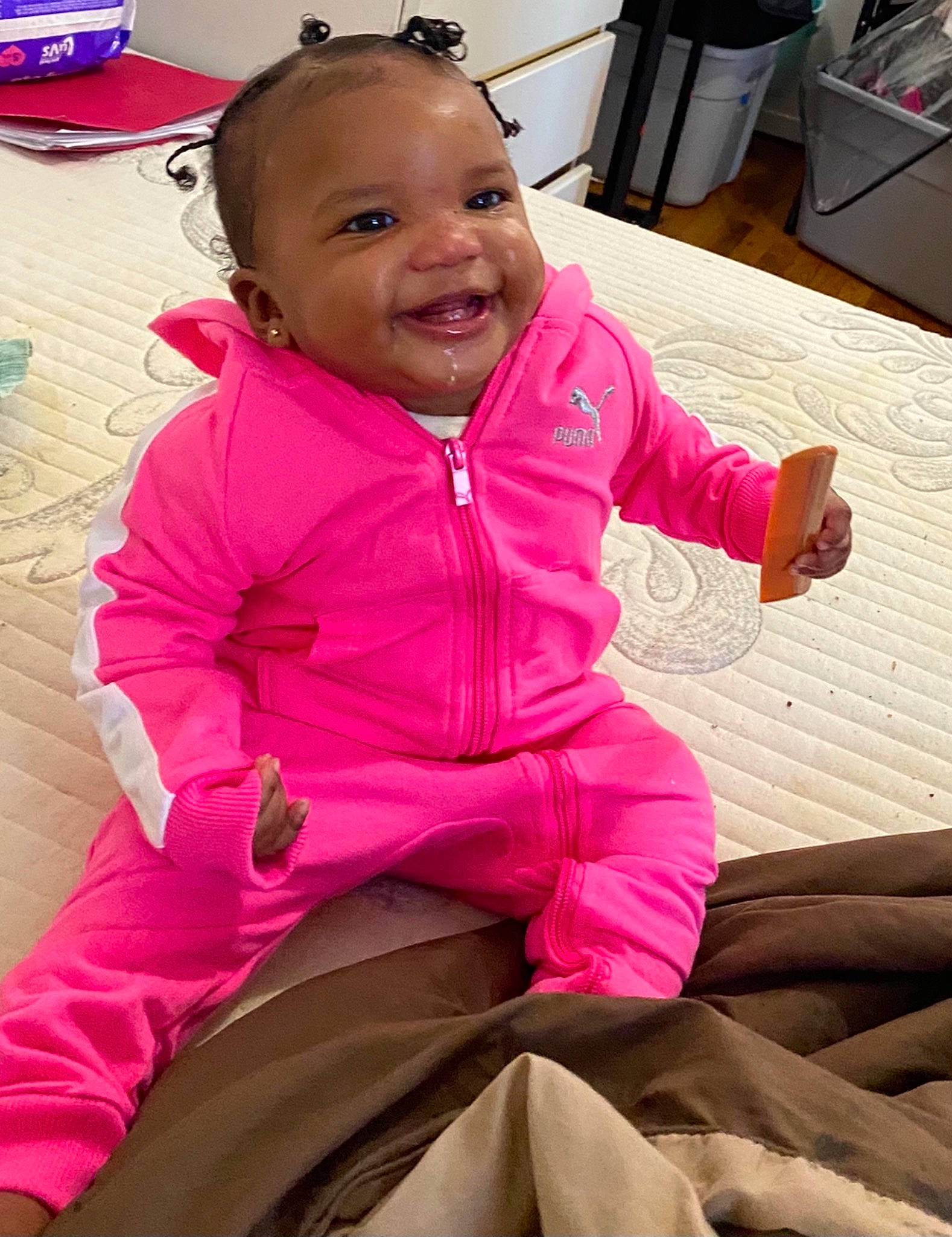 Janiyah is registered to the contest to win money with this photo: baby_toddler_clothing, cheek, comfort, eye, face, facial_expression, fun, hairstyle, happy, head, human, mouth, organ, person, photograph, pink, purple, skin, sleeve, smile