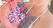 Araya Hope joined the competition — help win amazing prizes! baby, woman, tattoos, outdoor, hat, child, holding, affection, summer, sunhat, portrait, person, cute, patterned_clothing, nature, family, love, casual, daylight, shade