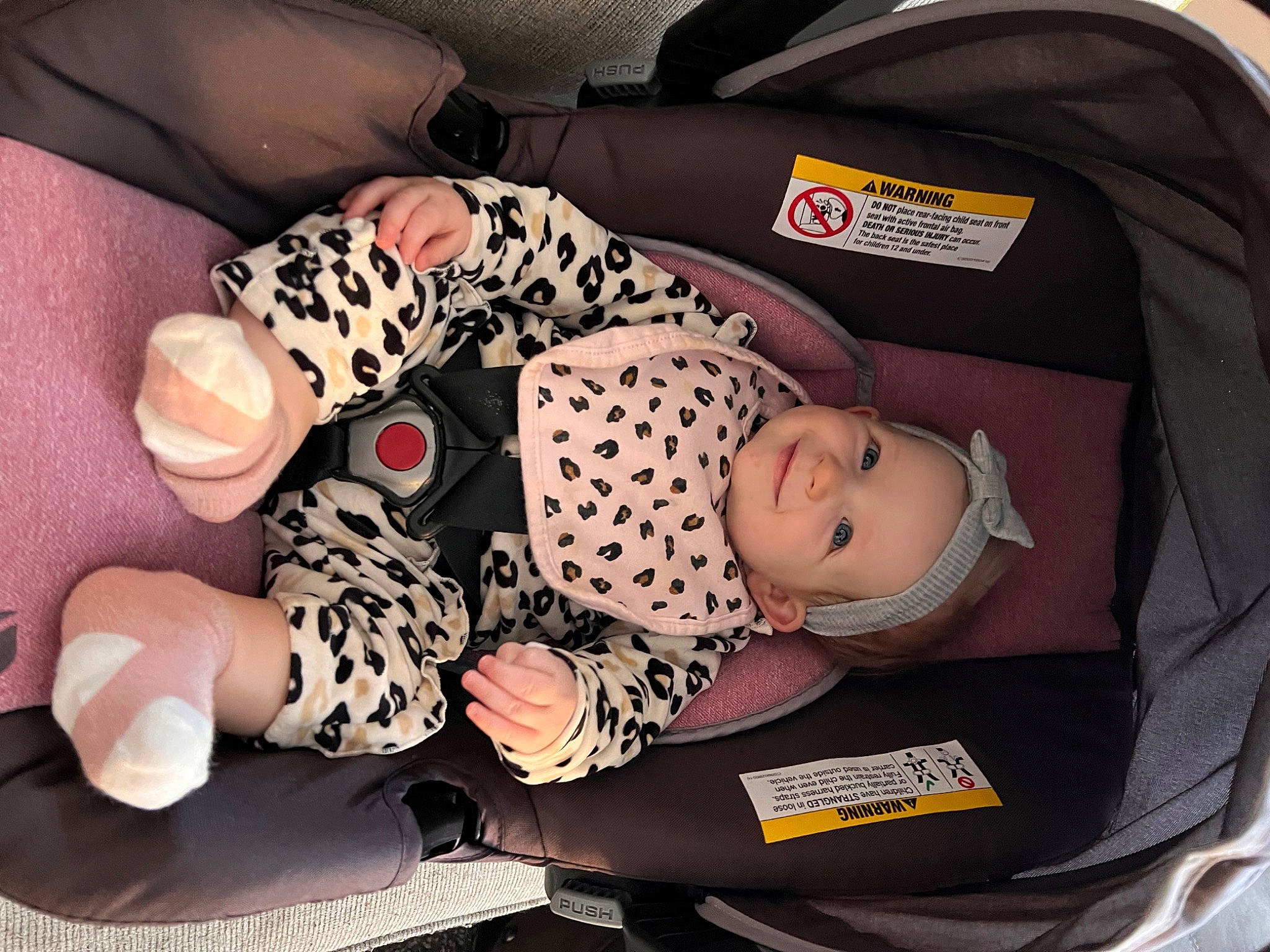 Brynlee is registered to the contest to win money with this photo: baby, baby_carriage, baby_products, baby_toddler_clothing, bag, car_seat, carmine, child, comfort, foot, headwear, human_leg, joy, lap, motor_vehicle, pattern, person, product, sitting, sleeve