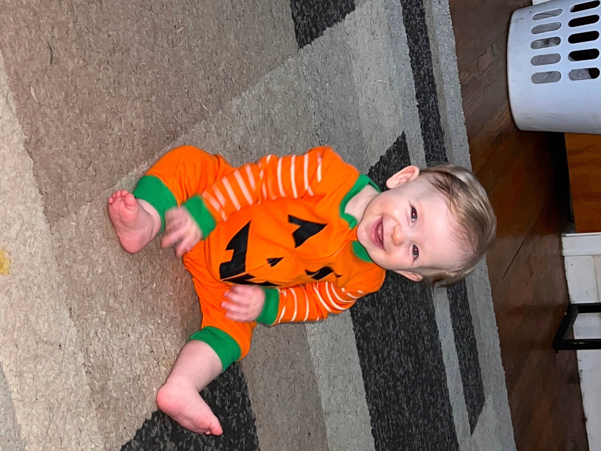 Brynlee joined the competition — help win amazing prizes! baby, baby_products, baby_toddler_clothing, child, flooring, foot, fun, grass, happy, joy, orange, person, sitting, smile, sock, toddler, tree, vacation, wood