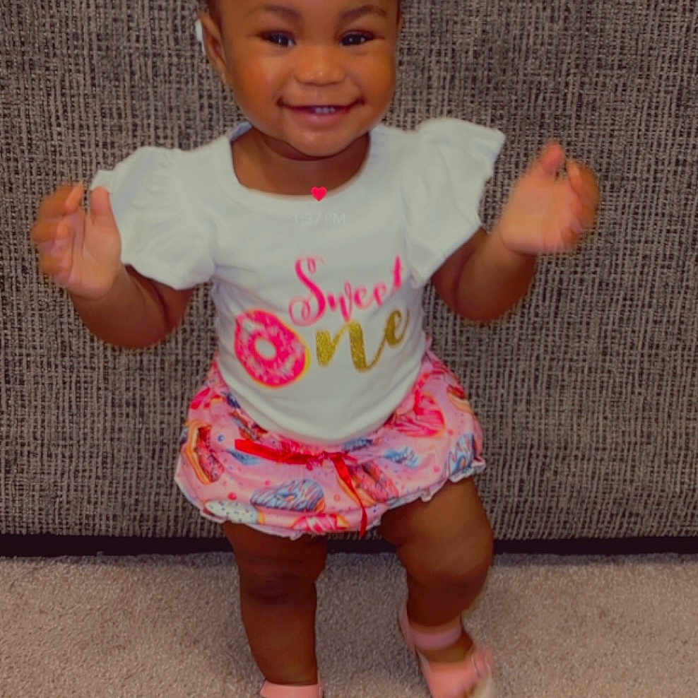 Kahlani joined the competition — help win amazing prizes! accessories, baby, bodypart, clothing, couch, dress, face, finger, footwear, furniture, hand, happy, head, person, photography, portrait, sandal, shoe, shorts, t_shirt