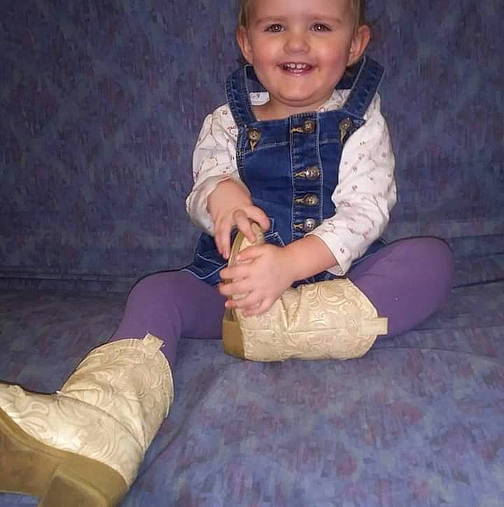 Emma Jo is registered to the contest to win money with this photo: baby_toddler_clothing, child, comfort, dress, face, finger, flash_photography, hand, happy, headwear, human_leg, joy, knee, leg, outerwear, person, shoe, skin, sleeve, smile