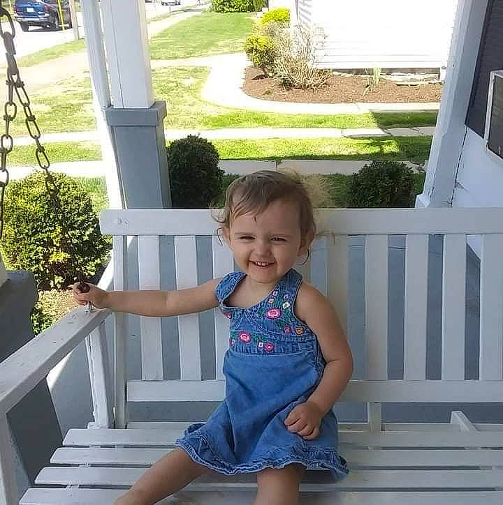 Emma Jo is registered to the contest to win money with this photo: baby_toddler_clothing, barefoot, black, dress, fun, grass, green, hairstyle, happy, human_leg, joy, leisure, light, line, person, plant, sleeve, smile, toddler, tree