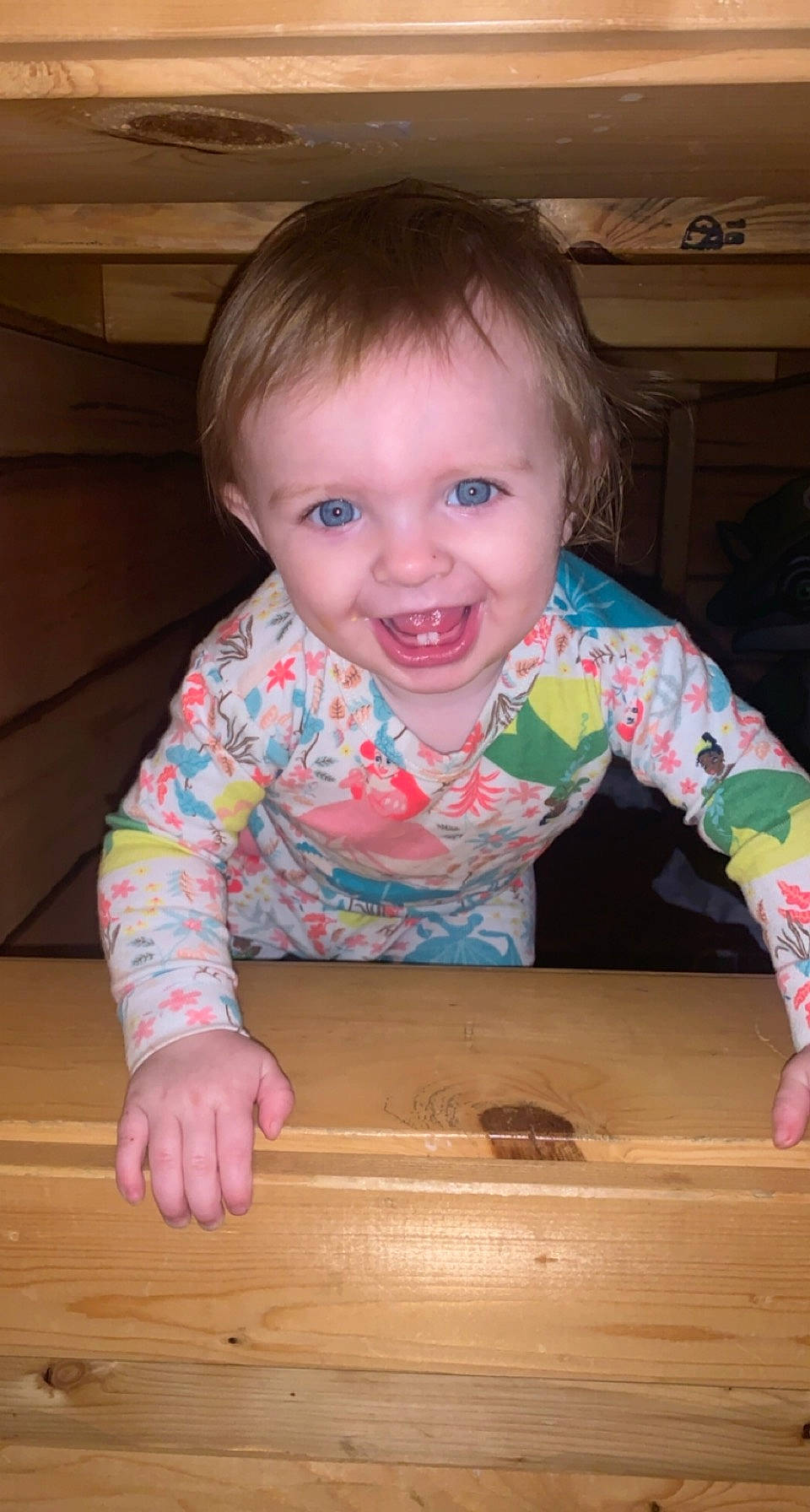 Scarlett is registered to the contest to win money with this photo: baby_toddler_clothing, cheek, child, clothing, facial_expression, finger, floor, flooring, fun, hardwood, joy, pattern, person, skin, sleeve, smile, standing, t_shirt, toddler, varnish