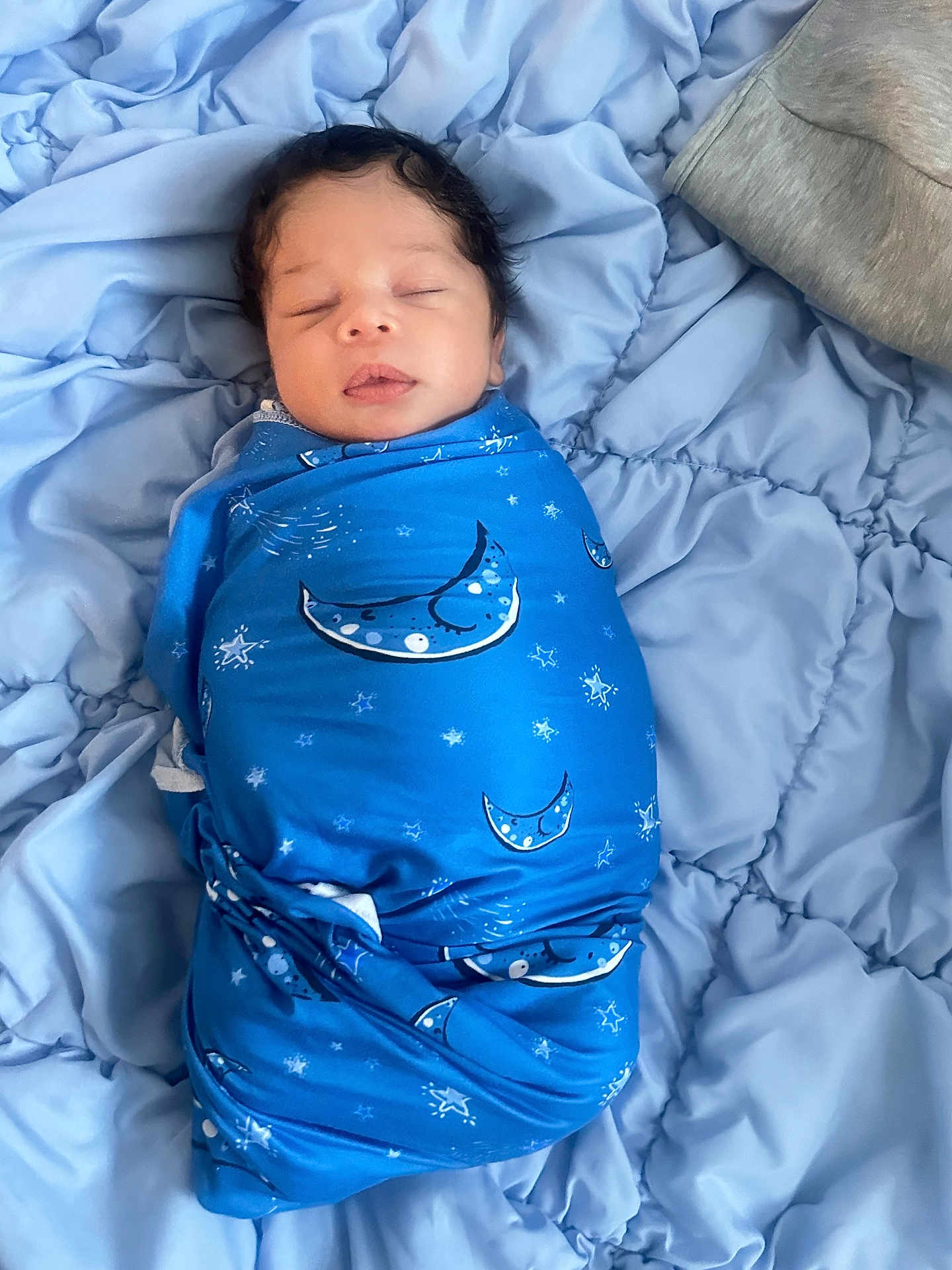 Aidan Jr joined the competition — help win amazing prizes! newborn, baby, sleeping, swaddle, blue_blanket, moon_pattern, stars, quilt, soft_texture, infant, peaceful, wrapped, cozy, lying_down, face, closed_eyes, indoor, portrait, cute, resting