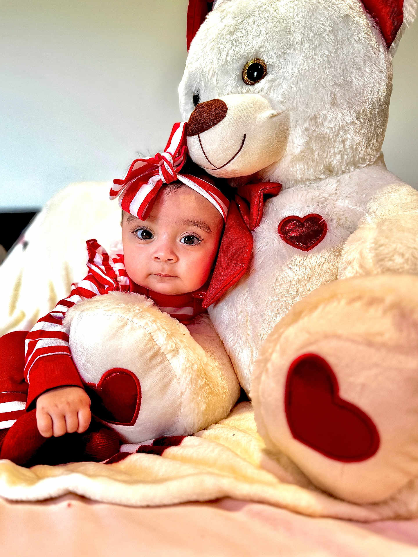 Ainnara joined the competition — help win amazing prizes! baby, child, teddy_bear, plush_toy, red_and_white, striped_clothing, headband, heart_shape, cuddly, cute, soft_texture, indoor, blanket, comfort, portrait, smiling, hugging, infant, adorable, cozy