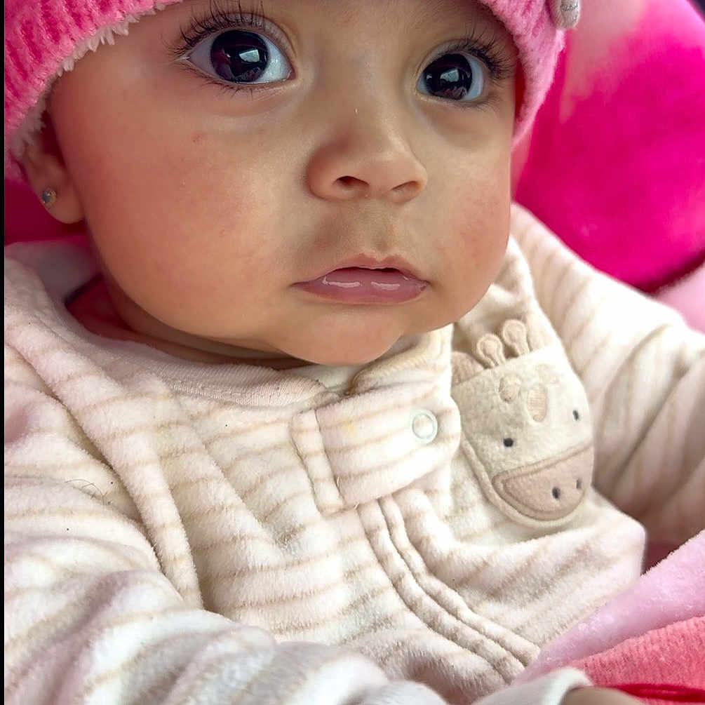 Ainnara joined the competition — help win amazing prizes! adorable, baby, car_seat, child, close_up, cozy, curious_look, cute, eyelashes, face, giraffe_patch, human, indoors, infant, knitted_hat, pink_hat, portrait, soft_texture, sweater, warm_colors