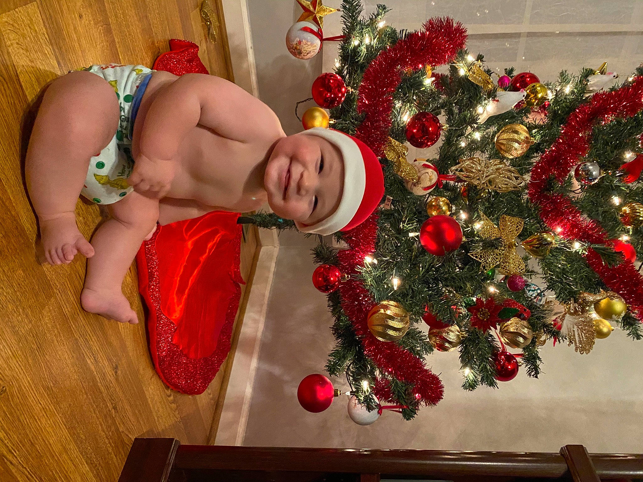 Adnan is registered to the contest to win money with this photo: abdomen, baby, baby_toddler_clothing, barechested, carmine, christmas, christmas_decoration, christmas_eve, christmas_ornament, christmas_tree, event, headwear, holiday, holiday_ornament, interior_design, joy, ornament, person, red, stomach