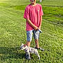 Lucey is registered to the contest to win money with this photo: boy, child, dog, french_bulldog, puppy, leash, grass, outdoor, summer, casual_clothing, shorts, tshirt, greenery, sunlight, smiling, pet, animal, walking, playful, happy