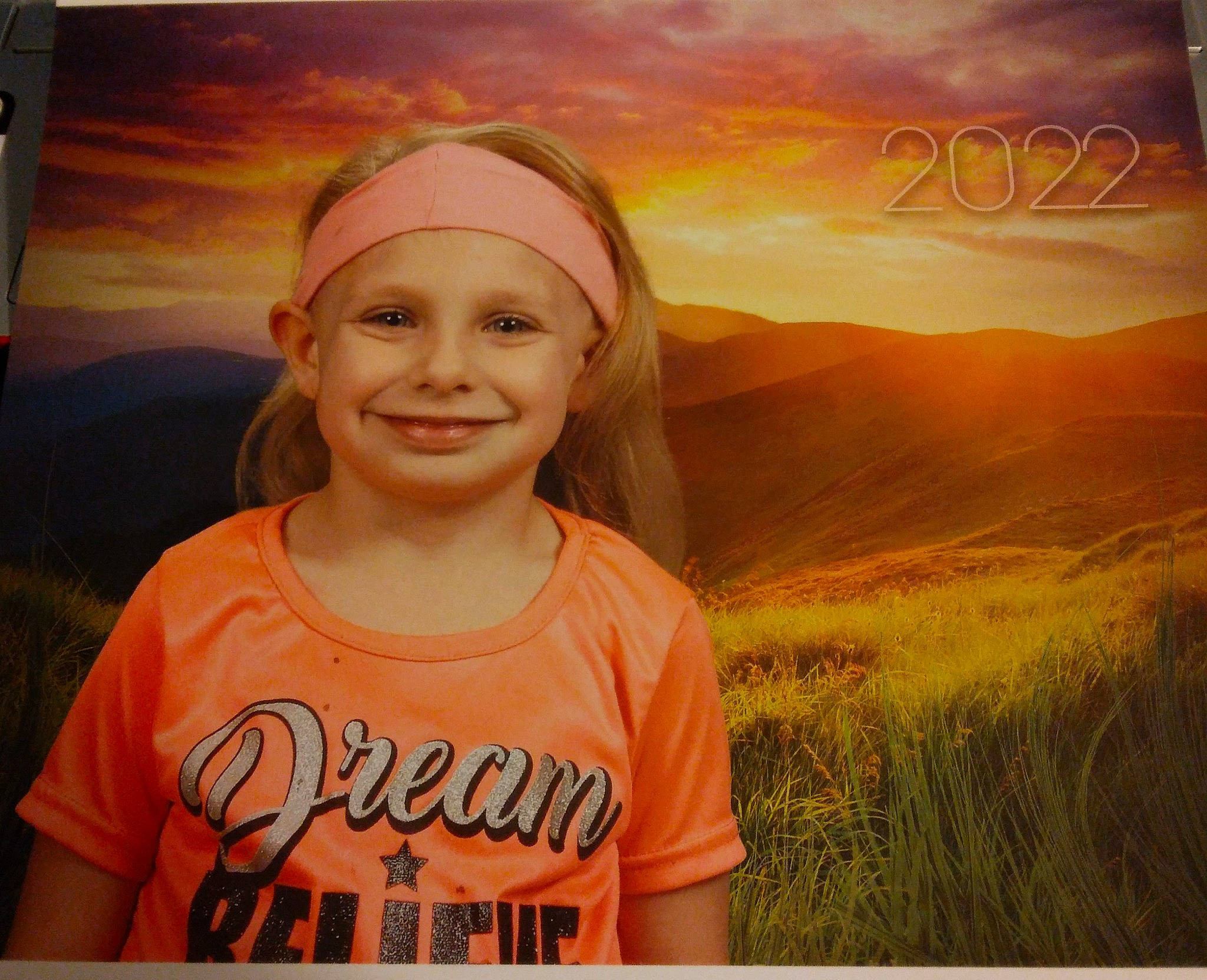 Raven is registered to the contest to win money with this photo: art, blond, child, cloud, flash_photography, fun, grass, grassland, happy, headwear, joy, landscape, morning, orange, painting, people_in_nature, person, sky, smile, sunrise