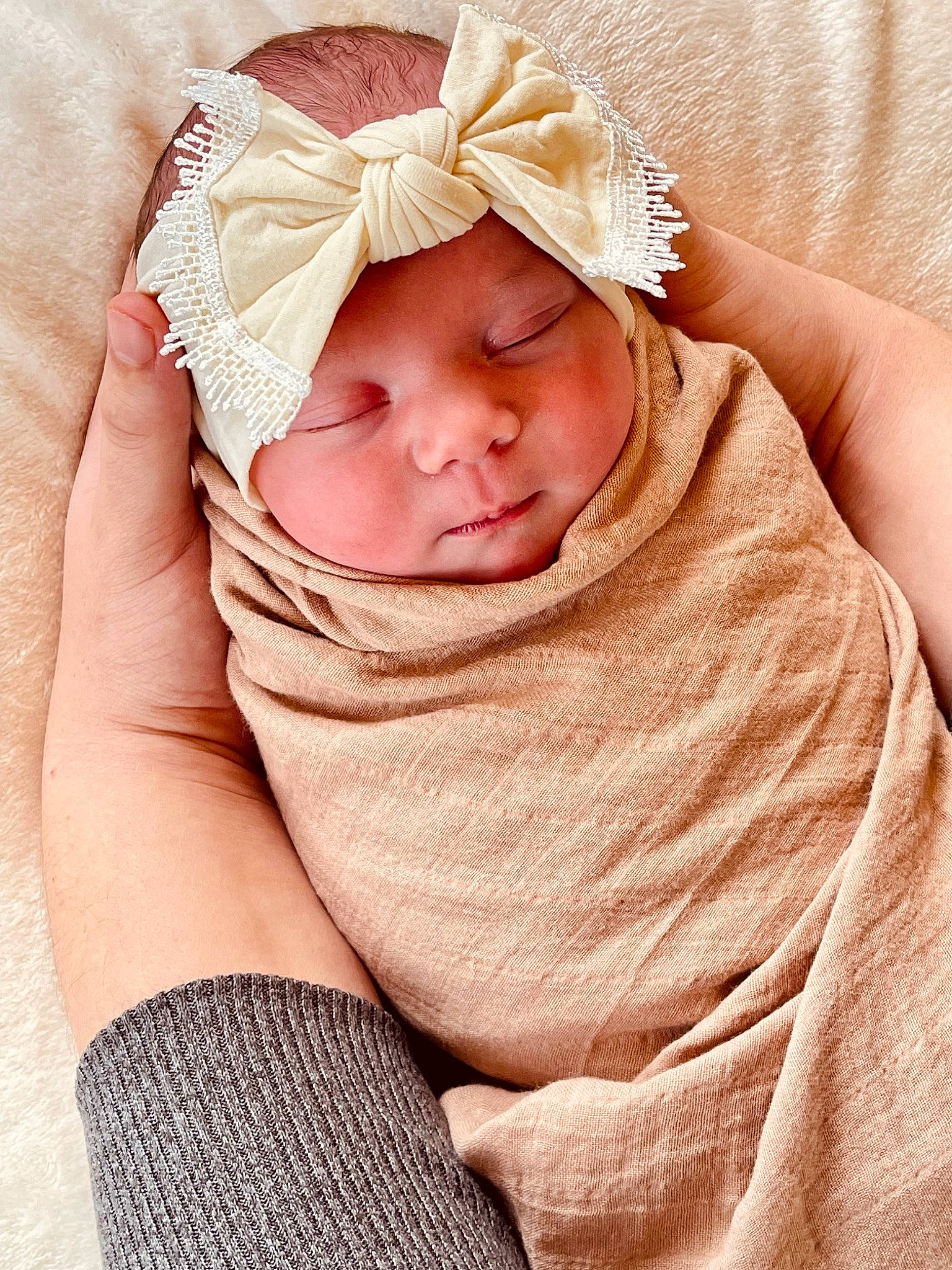 Cedar is registered to the contest to win money with this photo: arm, baby, baby_sleeping, baby_toddler_clothing, comfort, eye, fashion_accessory, hand, happy, headwear, linens, lip, pattern, peach, person, pink, skin, sleeve, smile, textile