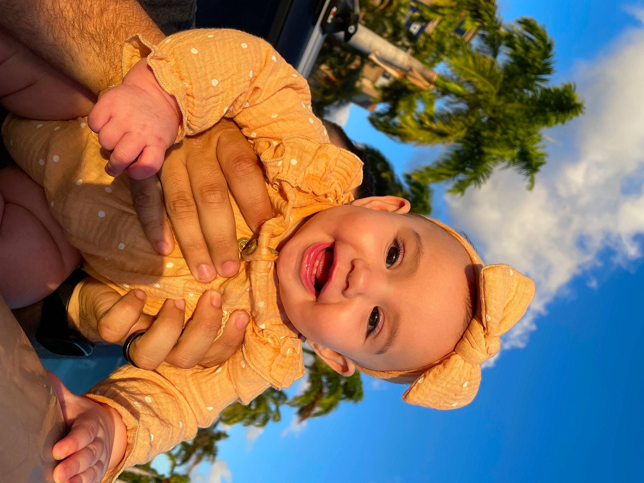 Aqua is registered to the contest to win money with this photo: baby, cloud, facial_expression, flash_photography, fun, gesture, grass, happy, human, jewellery, leisure, mouth, organ, people_in_nature, person, plant, skin, sky, smile, toddler