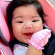 Amara Adame joined the competition — help win amazing prizes! baby, infant, smile, pink_mitten, car_seat, child, dark_hair, cute, happy, face, close_up, indoor, seatbelt, apparel, young_child, head, skin, cheeks, expression, comfort