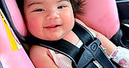Amara Adame joined the competition — help win amazing prizes! baby, car_seat, pink, smile, happy, child, seatbelt, mittens, infant, cute, face, clothing, hair, child_safety, car_interior, closeup, person, rosy_cheeks, comfort, portrait