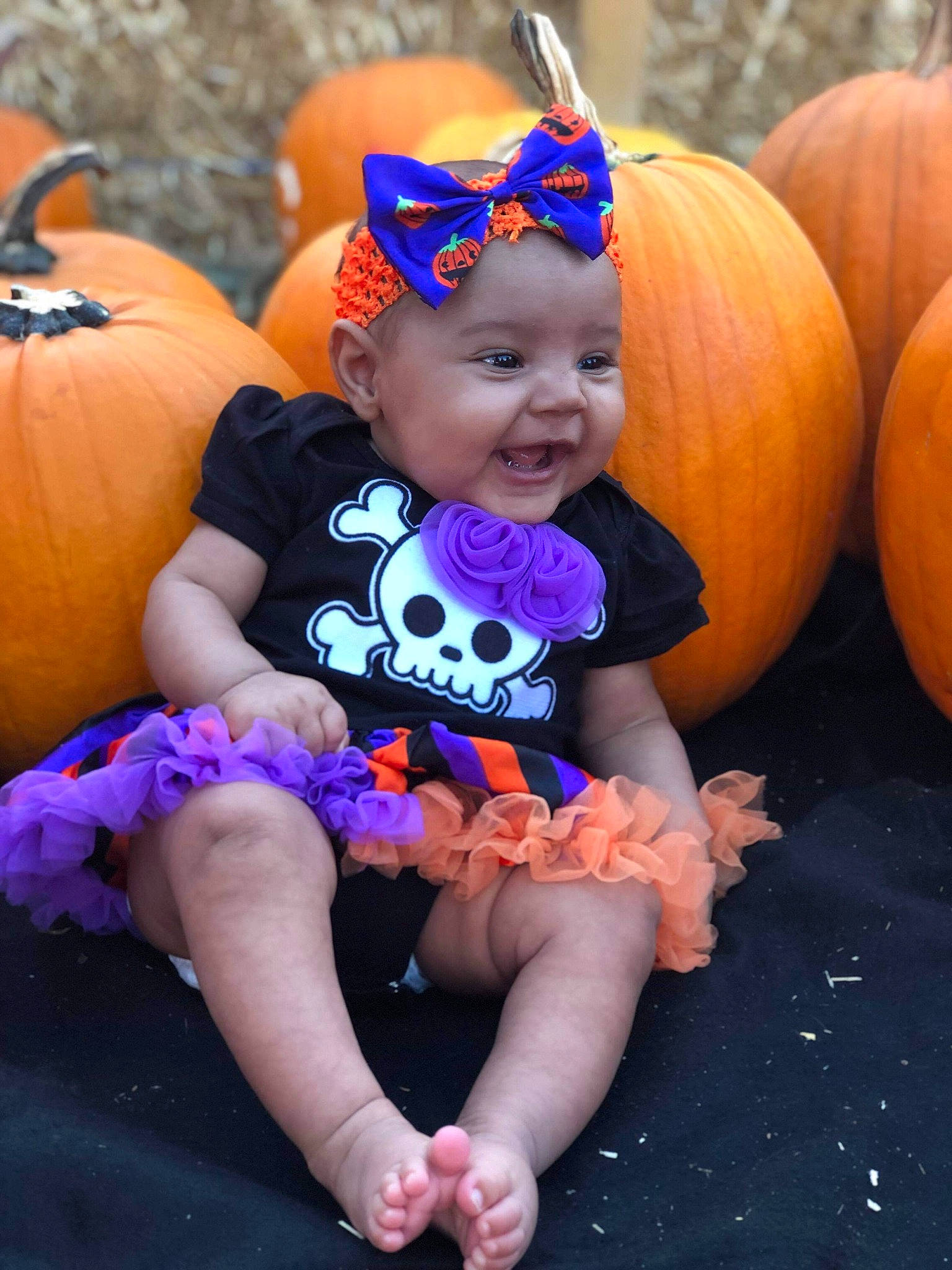 Leona is registered to the contest to win money with this photo: baby, calabaza, child, costume, cucurbita, face, fun, gourd, head, headgear, orange, person, pink, plant, pumpkin, purple, smile, squash, toddler, trick_or_treat