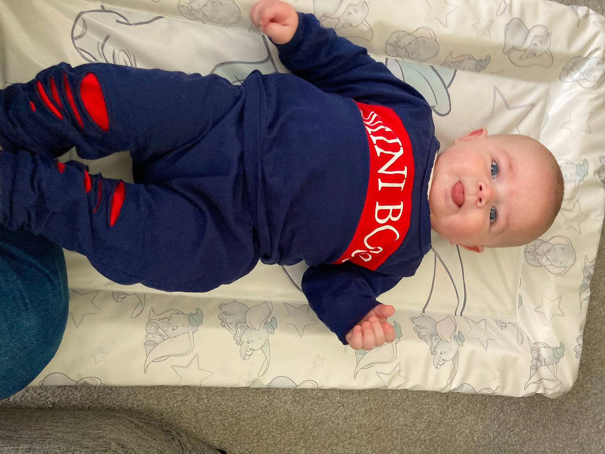 Jagger is registered to the contest to win money with this photo: baby, baby_sleeping, baby_toddler_clothing, carmine, child, comfort, elbow, flooring, foot, headgear, human_body, human_leg, knee, leg, mouth, person, sitting, sleeve, sportswear, thigh