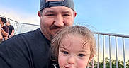 Blaire joined the competition — help win amazing prizes! child, toddler, man, cap, smile, outdoor, sky, fence, park, grass, people, shirt, text, friendship, happy, portrait, casual, daylight, family, fun