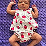 Lola is registered to the contest to win money with this photo: arms_up, baby, baby_clothes, barefoot, child, clothing, comfort, cute, head, infant, laying_down, legs, pattern, portrait, purple_blanket, skin, sleepy_eyes, small_hands, strawberry_print, texture