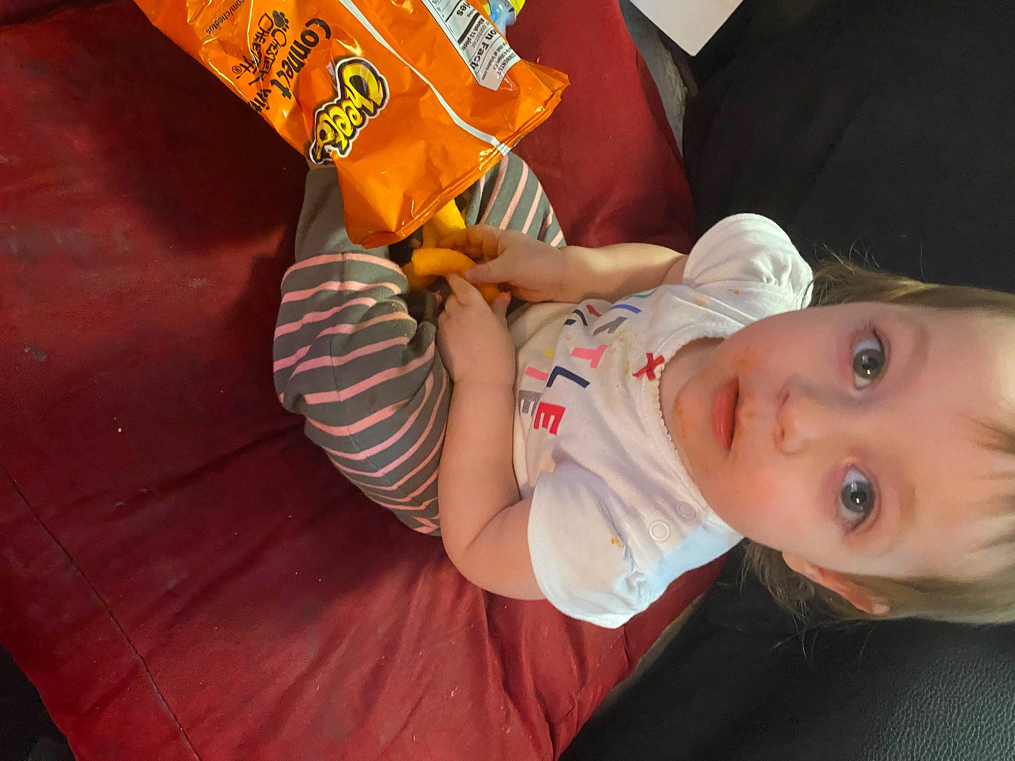 Emberlynn is registered to the contest to win money with this photo: baby, baby_toddler_clothing, child, elbow, foot, fun, grass, happy, human_leg, knee, logo, nail, orange, pattern, person, sitting, sleeve, t_shirt, thigh, toddler