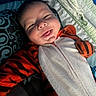 Malakai joined the competition — help win amazing prizes! baby, bed, blanket, child, clothing, costume, cozy, cute, face, happy, indoors, infant, person, pillow, portrait, sleepwear, smiling, tiger_onesie, tongue_out, young
