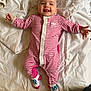 Nélia a rejoint le concours — aidez-le/la à gagner de superbes lots ! baby, child, smiling, onesie, pink_stripes, blanket, lying_down, happy, face, tongue_out, socks, infant, cute, indoors, soft_lighting, portrait, person, head, small_hands, cozy