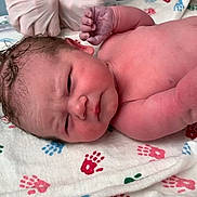 Calliope is registered to the contest to win money with this photo: newborn, baby, infant, hospital, gloves, hands, blanket, handprints, skin, wrinkled, medical, person, cute, fresh, birth, lying, red, pink, blue, green