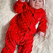 Emery joined the competition — help win amazing prizes! baby, infant, red_clothing, santa_hat, festive, christmas, soft_texture, fur_rug, sleepwear, cute, smiling, portrait, lying_down, holiday, child, one_person, indoors, cozy, warm, celebration