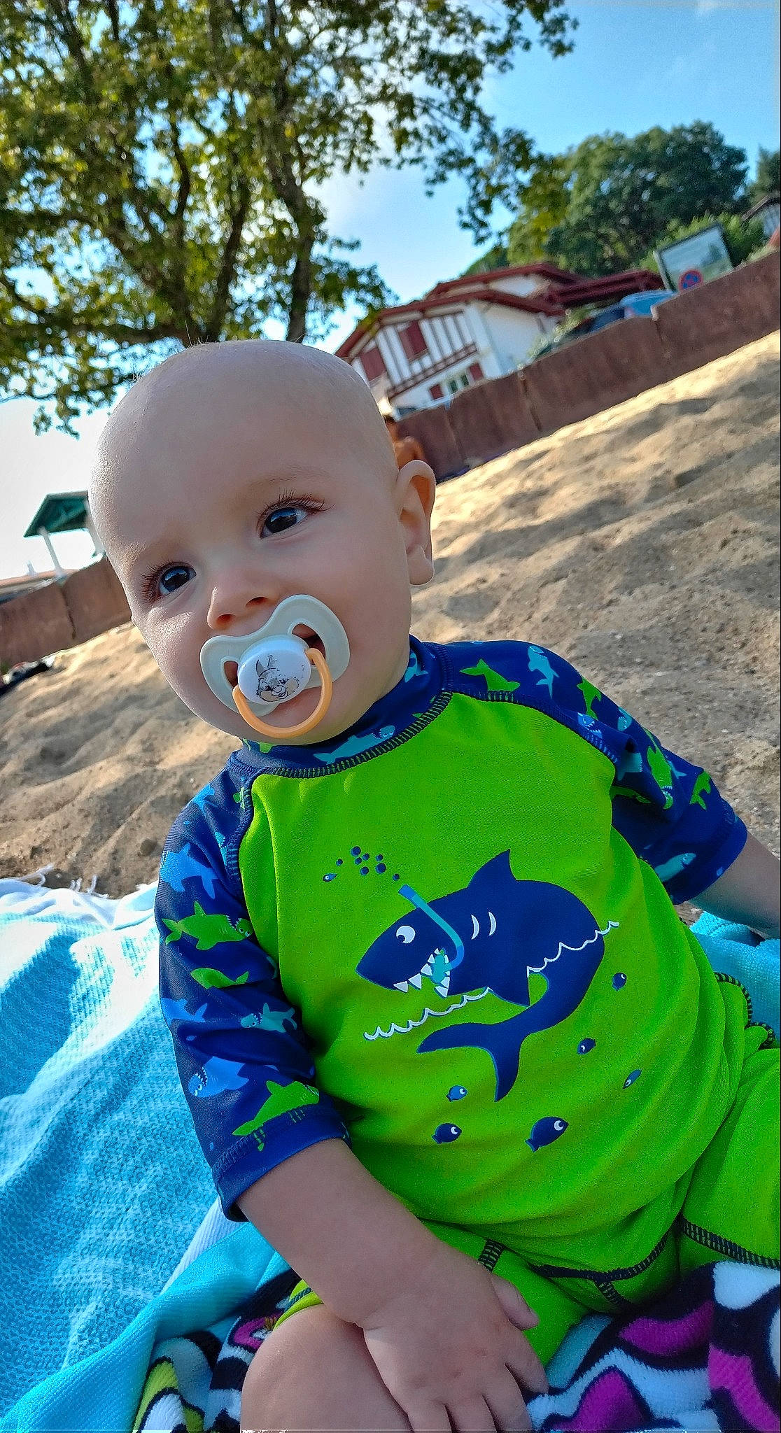 Logan participe au concours pour gagner de l'argent avec cette photo : azure, baby, baby_toddler_clothing, child, cool, electric_blue, fun, grass, happy, leaf, leisure, person, personal_protective_equipment, recreation, sitting, sky, sleeve, summer, t_shirt, toddler